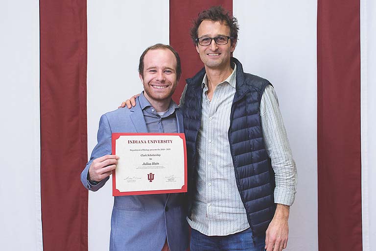 Julius Hain (left) and Rich Phillips pose for a picture as Julius holds up his Clark Scholarship certificate.